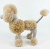 Side view of a 27-inch handmade alpaca poodle in natural beige fur, showing the rounded crown, long ears and leg cuffs