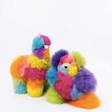 A fluffy alpaca fu llama plush toys in bright rainbow colors, one rainbow teddy bear standing and one sitting, photographed on a clean white background.