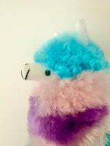 Close-up of Gummy Llama's hand-embroidered eye and snout, showing genuine hand-dyed alpaca fur in blue, pink, and purple