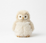 A beige alpaca fur owl stuffed animal standing on a white background, front view