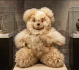 Luxury alpaca bear object styled as a sensory heirloom in a minimalist neutral nursery