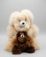 Natural beige 12 inch alpaca bear and chocolate brown 7 inch mini alpaca bear duo on neutral background.