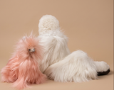 Suri alpaca luxury bundle pink alpaca stuffed toy and white fur slippers on beige background.