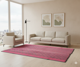 Modern living room with a pink rug, beige sofa, and armchair.