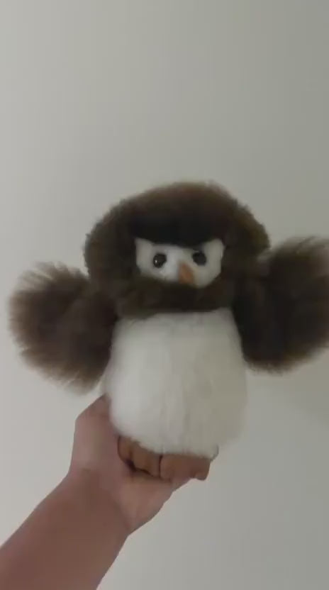 A short  sensory video showing a hand gently shaking a 12-inch handmade Huacaya alpaca fur owl plush, demonstrating the dense density and fluffy bounce of the premium natural fleece