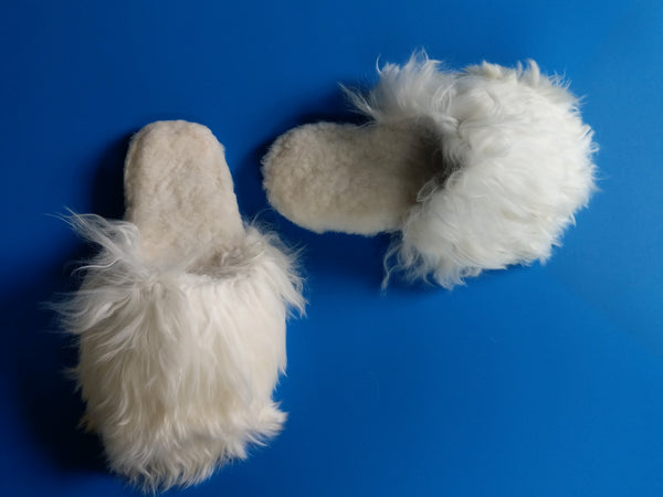 Close up of white Suri alpaca slippers with non-slip sole silk fiber luxury.