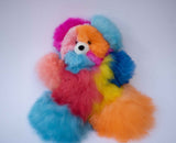 Large 12 inch rainbow alpaca plush bear standing for nursery shelf decor.