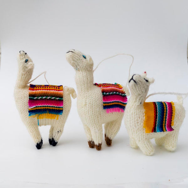 Set of three hand-knitted alpaca yarn llama Christmas ornaments, each with a different head position and a colorful woven textile accent on its back, handmade in the Andes of Peru