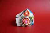 Hand-woven Peruvian wool belt with colorful floral embroidery.