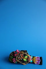 Colorful embroidered belt with floral designs on a blue background
