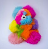 Detail of soft hand-dyed rainbow alpaca fiber on a limited edition stuffed bear.